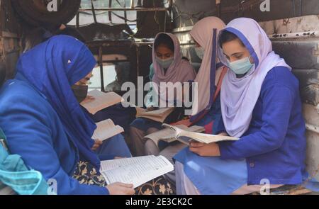 Lahore, Pakistan. 18th Jan, 2021. Pakistani students wearing face masks coming out after attending their first day of school at Kinnaird government school in Lahore. Pakistani government reopened educational institutes across the country from grade 9th to 12th after remaining closed as a preventive measure against the Covid-19 coronavirus. Pakistani authorities started to reopen schools in phases despite a steady increase in deaths and infections from the coronavirus, official said. (Photo by Rana Sajid Hussain/Pacific Press) Credit: Pacific Press Media Production Corp./Alamy Live News Stock Photo