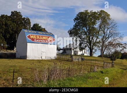 A barn on a farm near Lebanon, Missouri is painted with an advertisement for Meramec Caverns, a Route 66 tourist attraction near Stanton, Missouri. Stock Photo