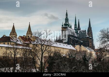 Postcard view of Prague Castle and St Vitus Cathedral,Czech republic.Famous tourist destination.Prague winter panorama.Snowy day in the city.Amazing E Stock Photo