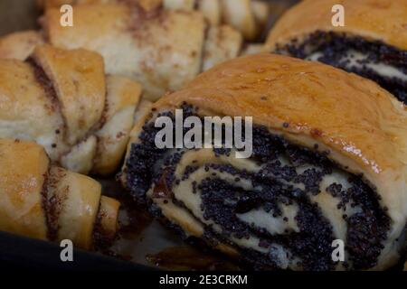 Rich pastries. The buns are on a baking sheet. Filling with poppy seeds ...