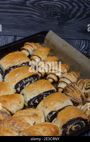 Rich pastries. The buns are on a baking sheet. Filling with poppy seeds ...