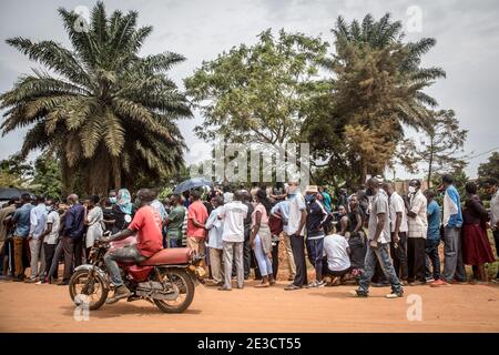 Kampala, Uganda. 15th Jan, 2021. Voters line up at the opposition leader Bobi Wine whose real name is Robert Kyagulanyi's local polling station in Magere, on the outskirts of Kampala, to cast their ballots during the presidential election. Uganda's elections, on January 14, 2021, were the most tense in decades. Credit: SOPA Images Limited/Alamy Live News Stock Photo