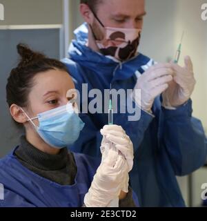 Paris, France. 18th Jan, 2021. French medical workers fill syringes with Covid-19 vaccine at the town hall of the 5th district in Paris on Monday, January 18, 2021. Nineteen Covid-19 vaccination centers are now open and administering Pfizer-BioNTech vaccines to seniors over age 75 and those with medical conditions that render them at-risk. The French government has declared a nationwide 6pm curfew instead of opting for a third national lockdown. Photo by David Silpa/UPI Credit: UPI/Alamy Live News Stock Photo