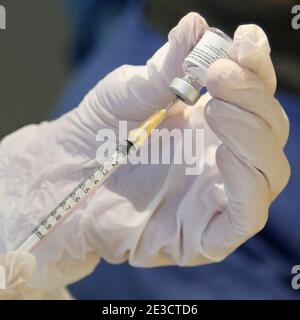 Paris, France. 18th Jan, 2021. A French medical worker fills a syringe with Covid-19 vaccine at the town hall of the 5th district in Paris on Monday, January 18, 2021. Nineteen Covid-19 vaccination centers are now open and administering Pfizer-BioNTech vaccines to seniors over age 75 and those with medical conditions that render them at-risk. The French government has declared a nationwide 6pm curfew instead of opting for a third national lockdown. Photo by David Silpa/UPI Credit: UPI/Alamy Live News Stock Photo