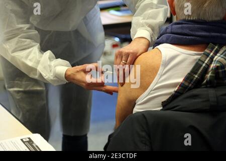 Paris, France. 18th Jan, 2021. A French medical worker administers a shot containing Covid-19 vaccine at the town hall of the 5th district in Paris on Monday, January 18, 2021. Nineteen Covid-19 vaccination centers are now open and administering Pfizer-BioNTech vaccines to seniors over age 75 and those with medical conditions that render them at-risk. The French government has declared a nationwide 6pm curfew instead of opting for a third national lockdown. Photo by David Silpa/UPI Credit: UPI/Alamy Live News Stock Photo