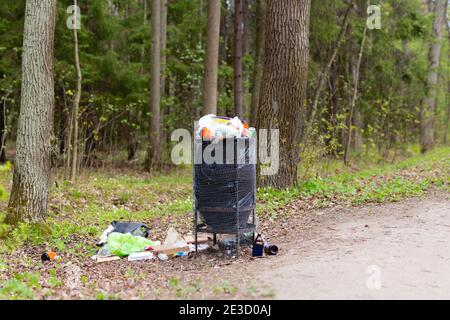 Garbage waste in park full of all sort of trash. Spring summer time. Save planet environment Stock Photo