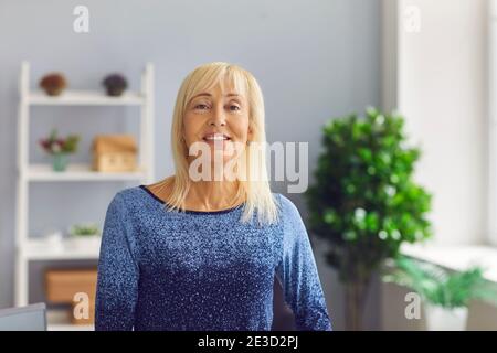 Portrait of a sincere and kind middle aged mature woman who is looking at the camera. Stock Photo