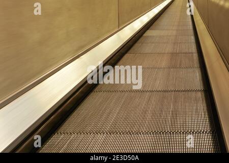 Flat escalator - moving walkway travelator in underground train station Stock Photo
