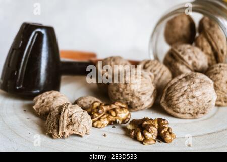 Close-up of walnuts and nutcrackers on a rustic wooden table. Stock Photo