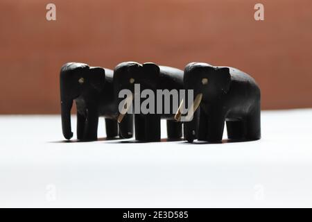 Tiny elephants by black timber made in 1960's (very old uncompleted set) Stock Photo