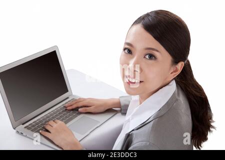 Portrait of young businesswoman sitting in front of laptop,high view high quality photo Stock Photo