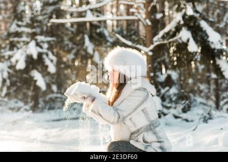 Portrait of young woman in the frosty winter forest Stock Photo