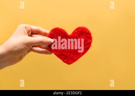 Red decorative heart in hand. Love symbol. Stock Photo
