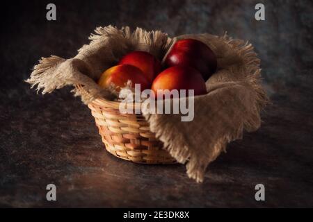 Ripe and juicy nectarines in a basket  Stock Photo