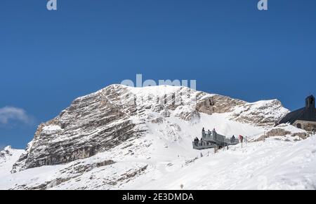 Zugspitze, Germany - Aug 5, 2020: Tourist at observation deck in snowy summer time Stock Photo