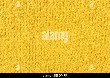 Abstract yellow fabric background and texture space for design. Top view sweater silk. Stock Photo