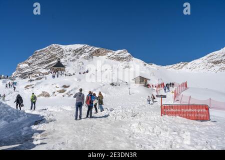 Zugspitze, Germany - Aug 5, 2020: Tourists walk on summer snow near Sonnalpin Stock Photo