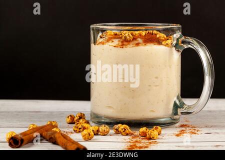 Traditional Turkish Boza, a fermented wheat and corn based drink popular in middle eastern countries in winter season. It is served with cinnamon and Stock Photo