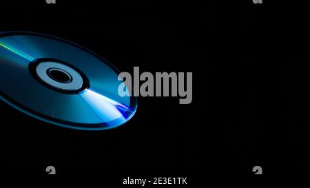 compact-disc in hand on a black background Stock Photo