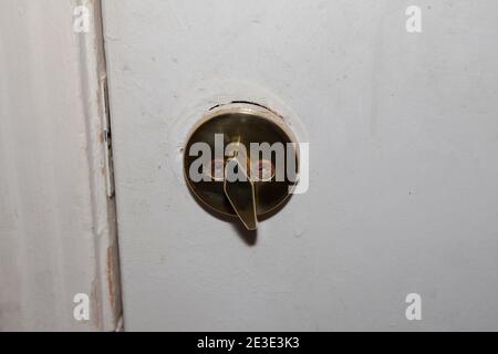 Deadbolt on an old white door not locked Stock Photo