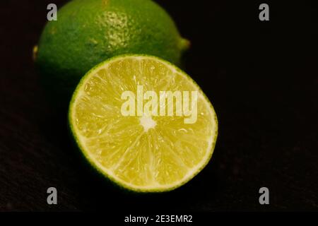 fresh lime in close up, isolated with black background Stock Photo