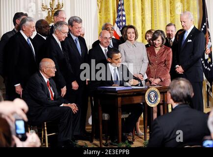 US President Barack Obama, surrounded by members of Congress and US Vice President Joe Biden (3rd R), signs the State Children's Health Insurance Program (SCHIP) bill in the East Room of the White House in Washington, DC, USA on February 4, 2009. Photo by Olivier Douliery/ABACAPRESS.COM Stock Photo