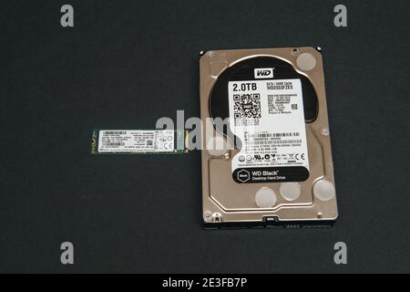 Paris, France - Jan 2, 2018: Comparing large HDD hard disk drive from Western Digital to small NVME SSD M2 disk from SK Hynix Stock Photo