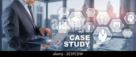 Businessman pressing case study button on virtual screens Stock Photo