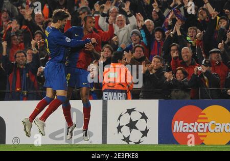 Barcelona's Thierry Henry celebrates after scoring with his team mate Gerard Pique during the Champions League second leg first knockout round soccer match, Barcelona vs Olympique Lyonnais at the Nou Camp, in Barcelona, Spain on March 11, 2009. Barcelona won 5-2 and FC Barcelona goes through on aggregate. Photo by Steeve McMay/ABACAPRESS.COM Stock Photo