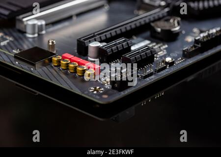 Motherboard on a table close-up, inside of a desktop computer showing chips, circuit boards and components Stock Photo