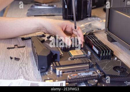 Installing a processor fan on the computer motherboard, PC assembly Stock Photo