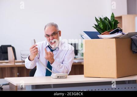 Old employee being fired from his work Stock Photo