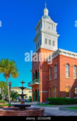 Classical Revival architecture of the Nassau County Courthouse with bell tower, steeple and fountain in historic Fernandina Beach, FL on Amelia Island Stock Photo