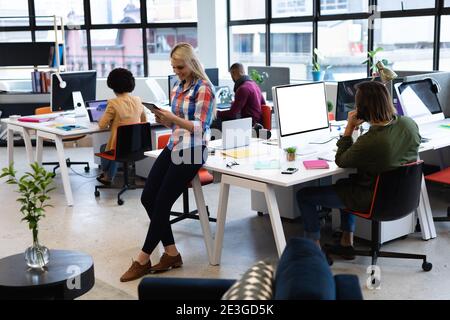 Caucasian businesswoman working in creative office Stock Photo