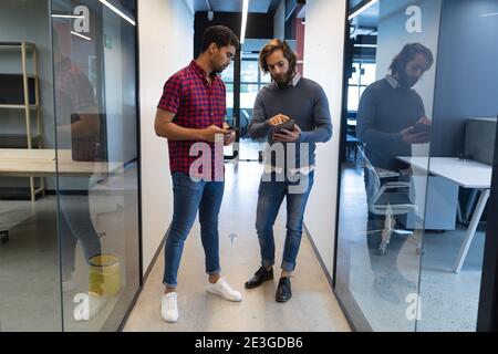 Two diverse businessmen working in creative office Stock Photo