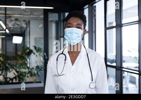 Mixed race female doctor standing looking at the camera and smiling Stock Photo