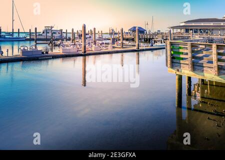 A serene view of sun flared water with yachts and sailboats at Oasis Marina at Fernandina Harbor, on the intracoastal waterway of Amelia Island, FL Stock Photo