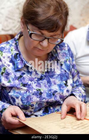 Portrait of a senior woman with menu Stock Photo