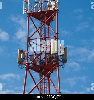 4G 5G cellular repeaters against a blue sky. Mobile phone Telecommunication Radio antenna Tower Stock Photo