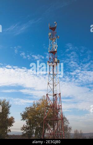 4G 5G cellular repeaters against a blue sky. Mobile phone Telecommunication Radio antenna Tower Stock Photo