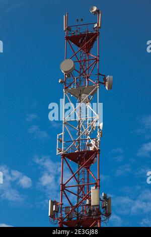 4G 5G cellular repeaters against a blue sky. Mobile phone Telecommunication Radio antenna Tower Stock Photo