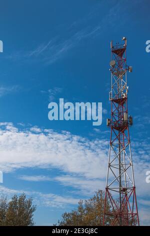 4G 5G cellular repeaters against a blue sky. Mobile phone Telecommunication Radio antenna Tower Stock Photo