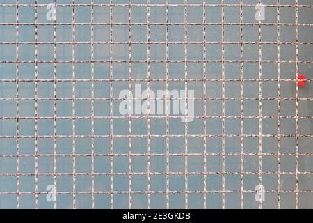 A metal grid background. Protective mesh on a light blue background. Steel net with copy space. High quality photo Stock Photo