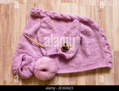 knitted jacket for a girl, pink color, knitting texture, handicraft ...