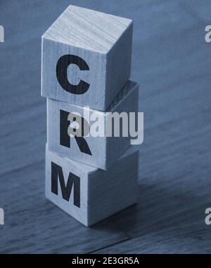 CRM, Customer Relationship Management, loyalty program, repeat purchase frequency concept, cube wooden block with alphabet combine the word abbreviati Stock Photo