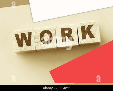 Workword made with wooden blocks and wallet on pink . Job salary money freelance concept. Stock Photo