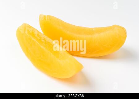 Canned peaches on a white background Stock Photo