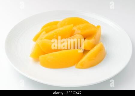 Canned peaches on a white background Stock Photo