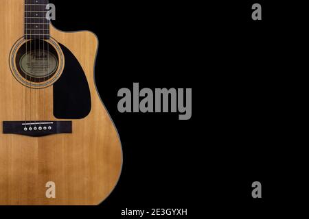 body part of classic yellow acoustic guitar Fender CD-60 with black pickguard on isolated black background with space for text Stock Photo