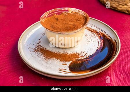 Tiramisu coffee-flavoured dessert served in a restaurant of Milan, Lombardy, Italy Stock Photo